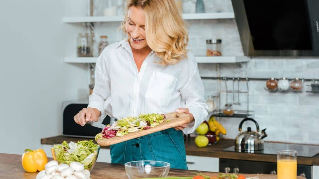 Woman Making Salad Food In The Kitchen