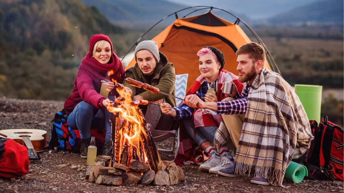 Four People Friends Camping In The Mountains Cooking Food