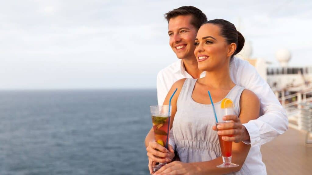 Couple On The Cruise Holding Cocktails