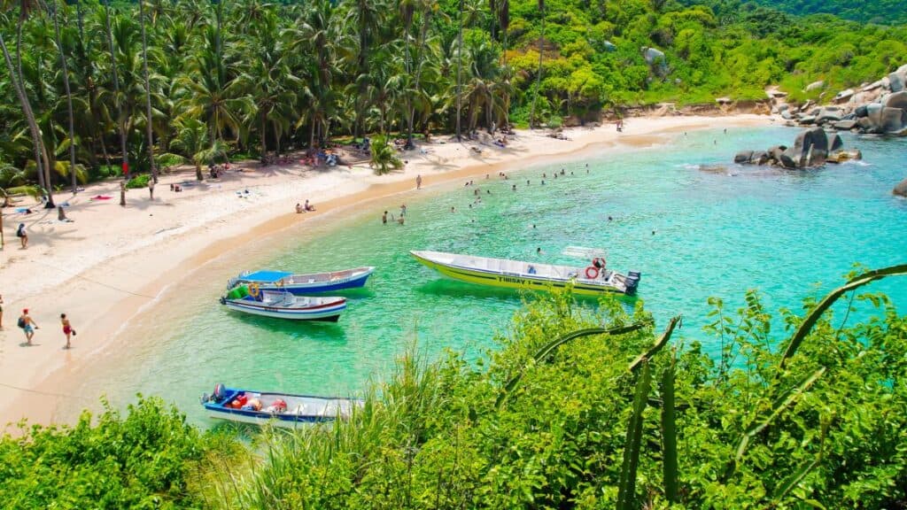 Boats And Tourists On The Shore Of Cabo San Juan Beach In Tayrona Natural Park Colombia Stock