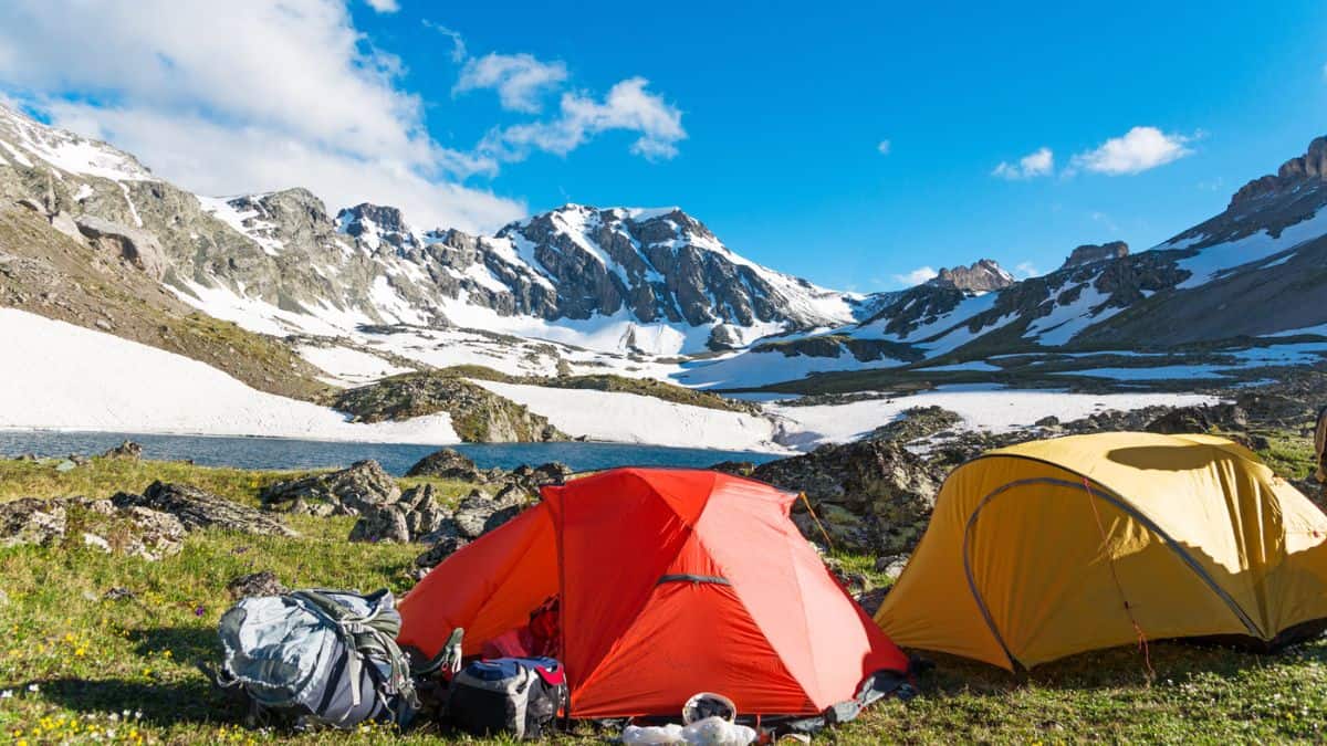 Two Camping Tents In Front Of Snowy Mountains