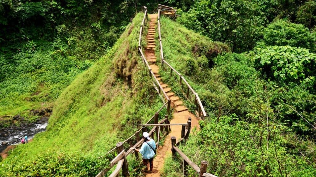 Traveler walking go to viewpoint of Tad Yeuang waterfalls in Bolaven Plateau Stock