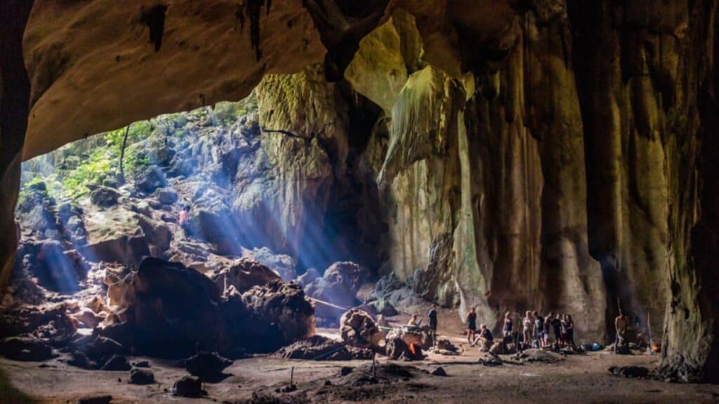 Tourists in a cave in the jungle of Taman Negara national park Stock