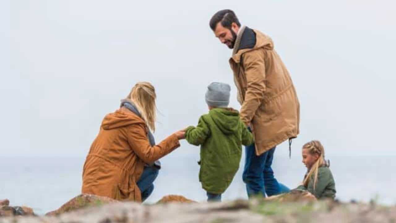 Family spending time on seashore stock