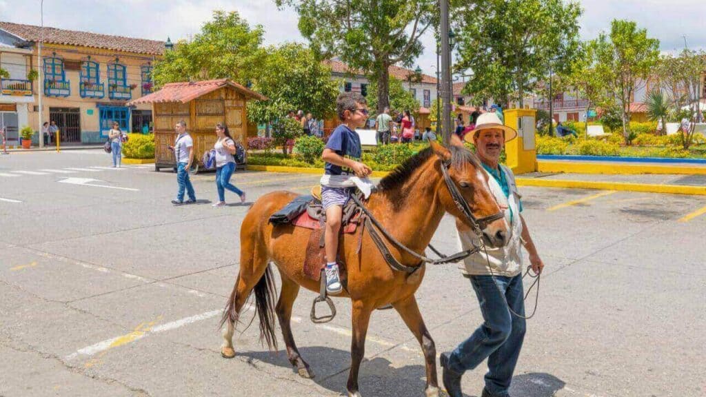 Horseback ride in the Bolivar Square in the village of Filandia Stock