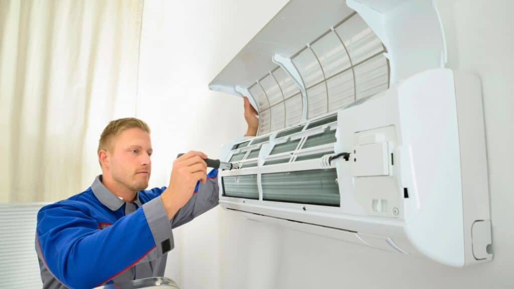 Man Repairing Air Conditioner Unit Stlock