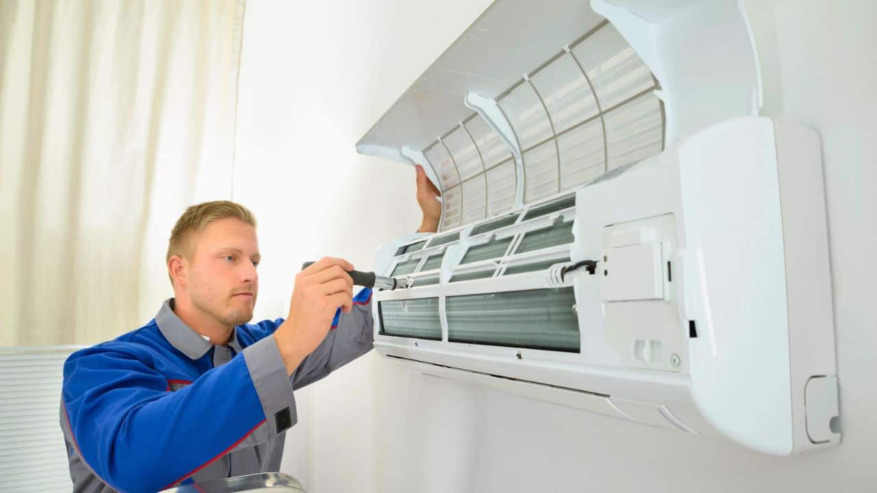 Man Repairing Air Conditioner Unit Stlock