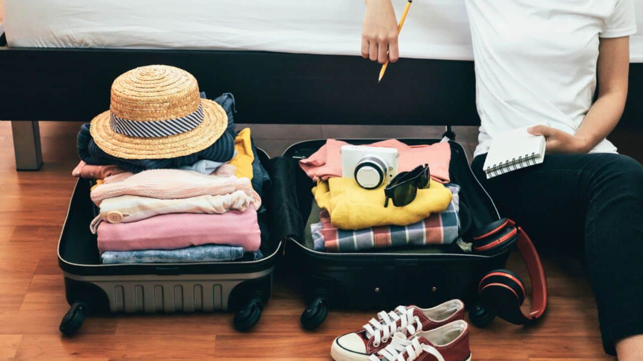 Preparation for vacation or travel. Packing his clothes and stuff stock