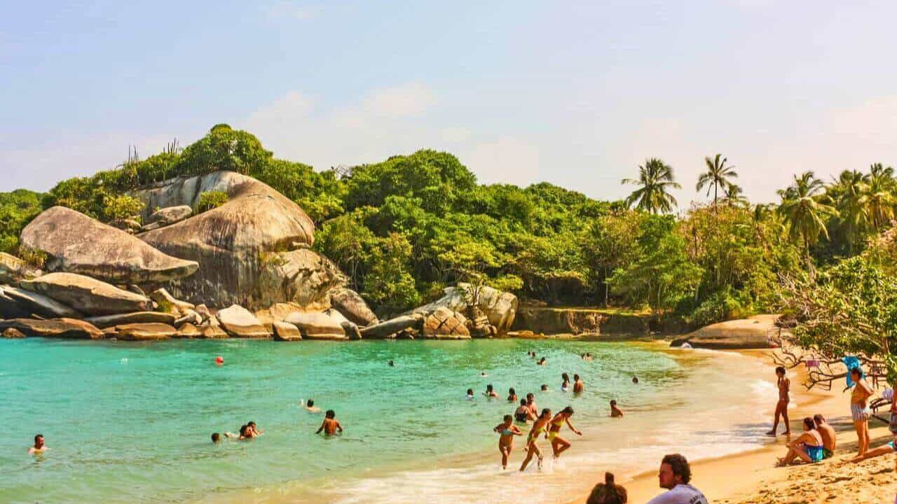 Tourists in Tayronal National Park enjoying the beach Stock