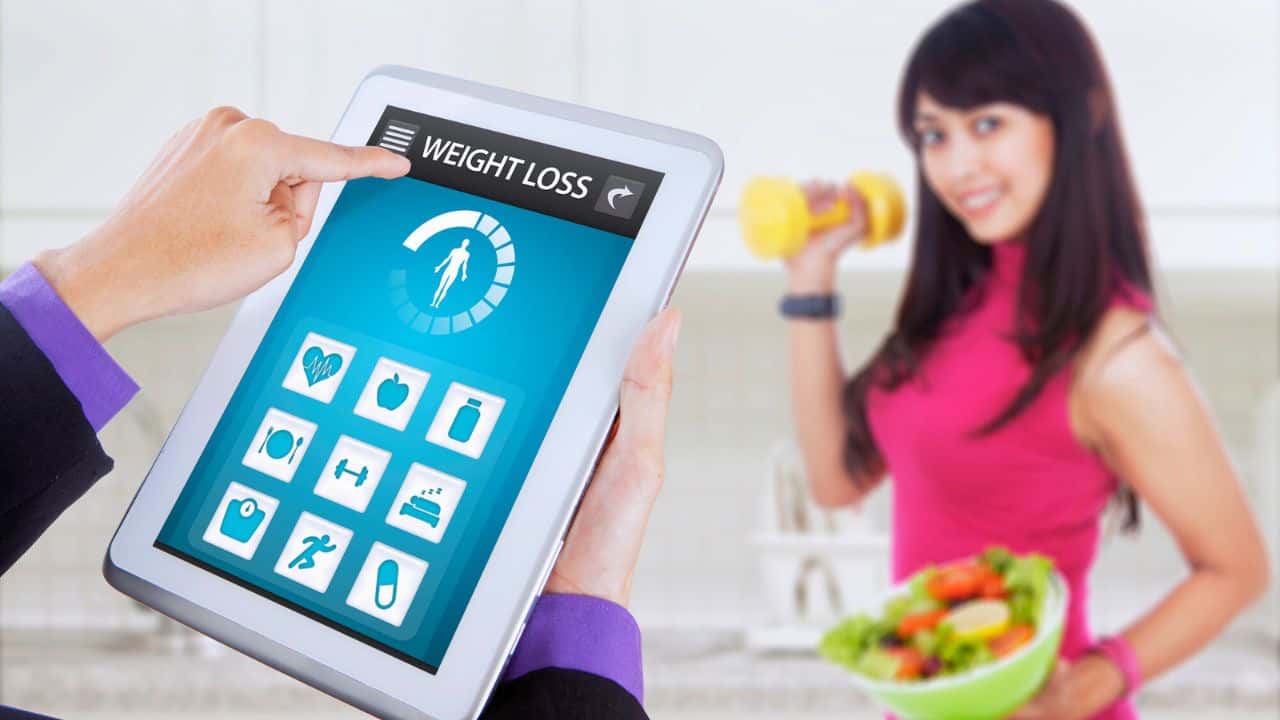 Weight loss app and healthy woman holds salad stock
