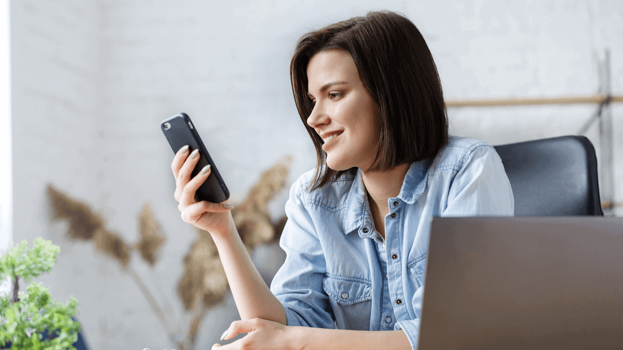 Woman Using Phone At Home Stock