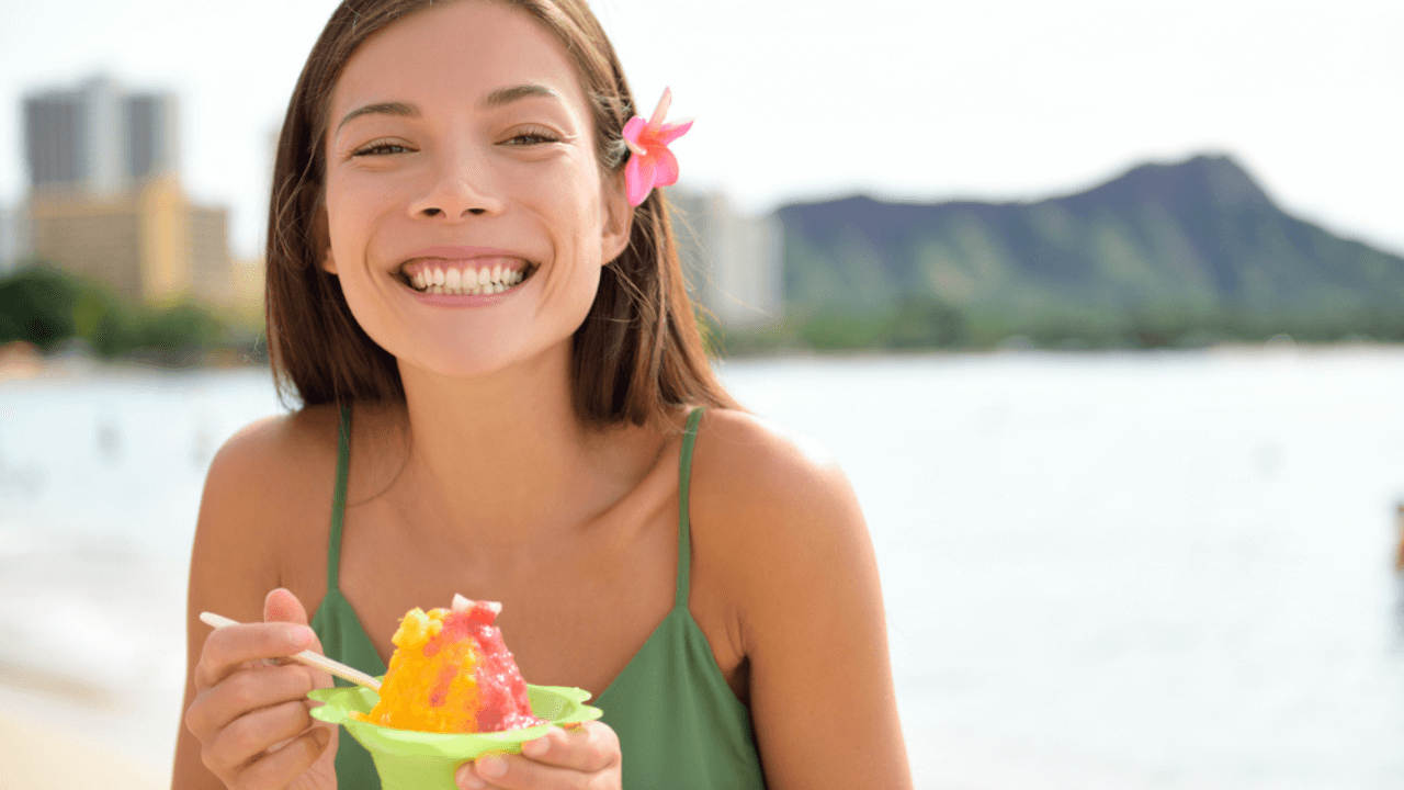 Woman on Waikiki Eating Hawaiian Shave Ice Stock