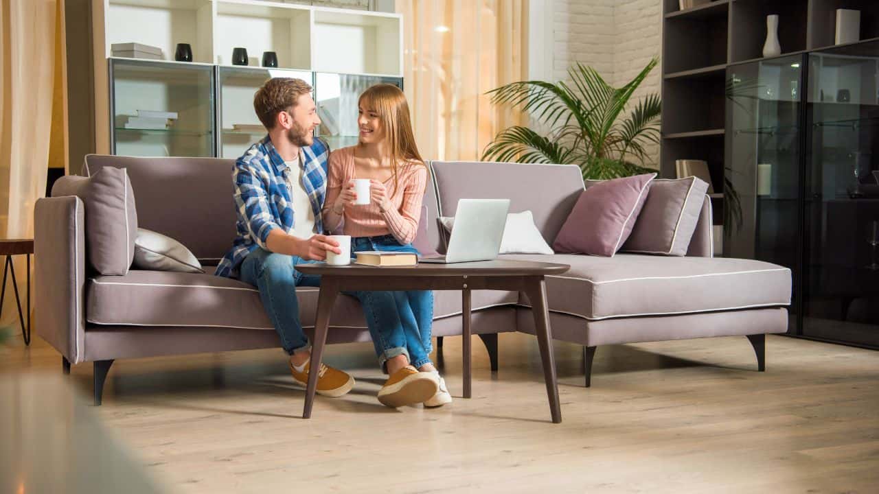 Young couple sitting on couch Stock