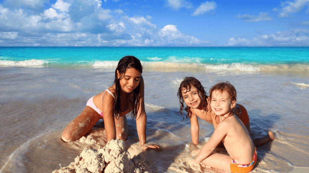 Three Girls Playing on the Beach Stock
