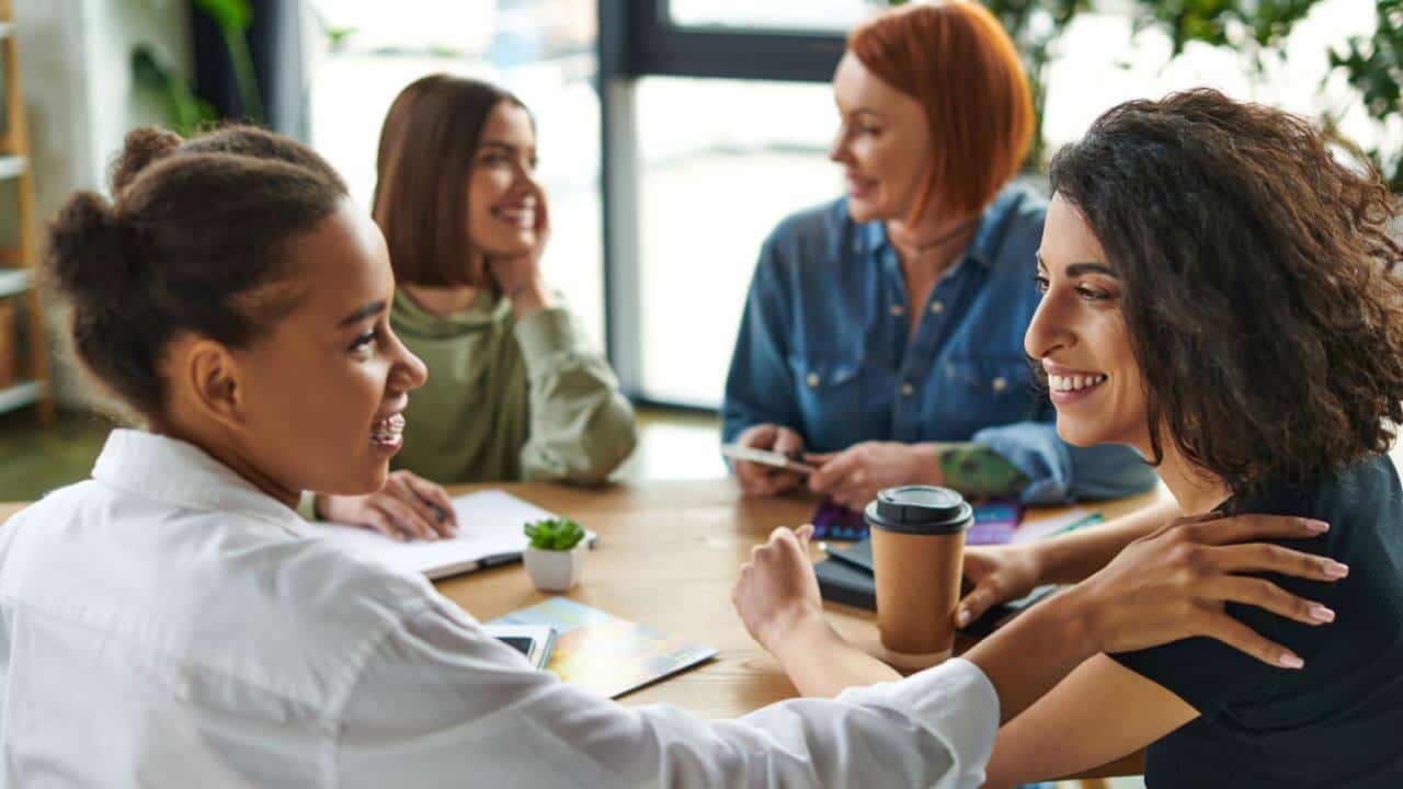 Cheerful Multiracial Women Having Coffee Stock