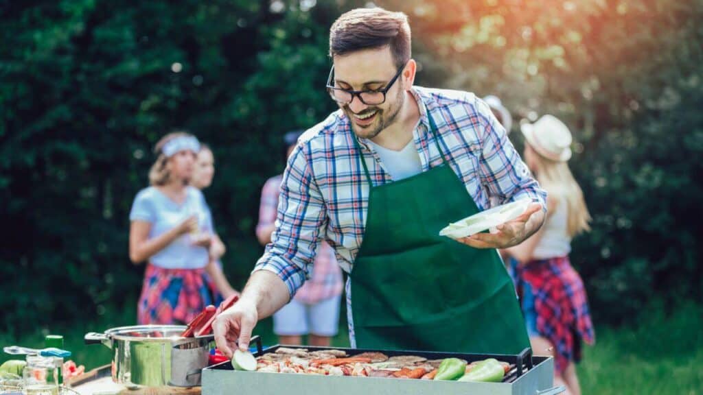 Man Preparing Barbecue Outdoor for Friends Stock